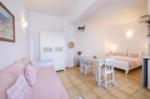 a living room with a couch and a table at Vrachia Studios & Apartments in Oia