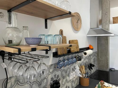 a kitchen with wine glasses on a shelf at Dharmia in Almodóvar del Río
