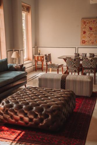 a living room with a couch and a table at Naila Kothi - A Luxury Boutique Royal Suites in Jaipur in Jaipur