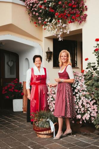 a man and a woman standing in front of a building at Gasthof Bocking in Söll