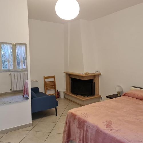 a bedroom with a bed and a couch and a fireplace at Angelo's House - Il Tanguero in Pellezzano
