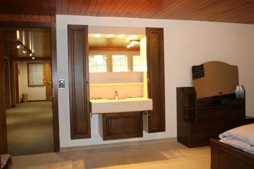 a bathroom with a sink and a window at Saastal Apartments Haus Antrona in Saas-Almagell
