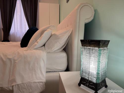 a bedroom with a bed and a lamp on a table at Emerella Luxury Suites-Siderno Lungomare in Siderno Marina