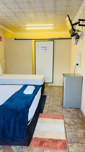 Ένα ή περισσότερα κρεβάτια σε δωμάτιο στο HostHub Guest House