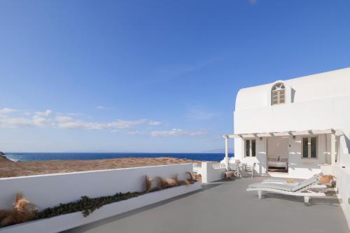 a white house with a view of the ocean at Vrachia Studios & Apartments in Oia