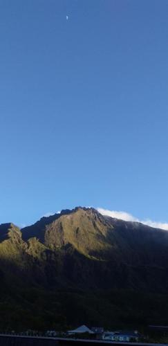 a view of a mountain with a blue sky at Gite Le Matarum, dortoire familiale 4 personnes in Cilaos