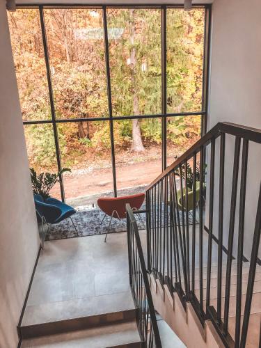 a room with a staircase with a large window at La Park Aparthotel in Kudowa-Zdrój