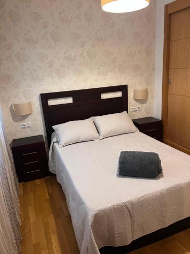 a bedroom with a large bed with a black headboard at Piso céntrico en zona monumental de Antequera in Antequera