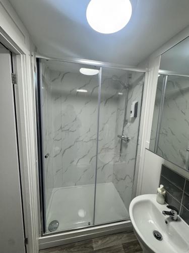 a bathroom with a shower and a sink at Fulforth St Studio Apartments in Nottingham