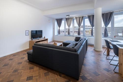 a living room with a couch and a table at NOMAD APARTMENTS - Henin in Charleroi