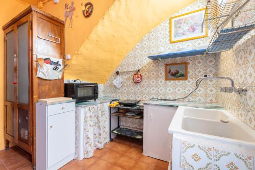a small kitchen with a sink and a counter at Casa Ratón Pérez in Navarrés