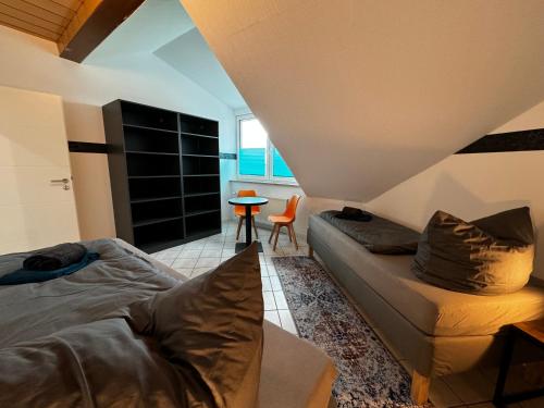 a bedroom with a bed and a chair and a table at 120m² Apartment nahe A1 - 4 Schlafzimmern - 2 Bäder - große Wohnküche - Grillplatz - Parkplatz in Siek