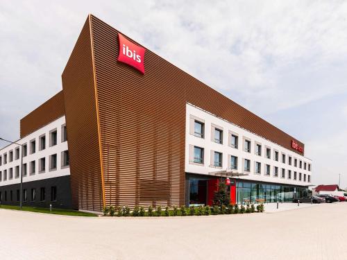 a large building with a lvs sign on it at Ibis Poznan Polnoc in Suchy Las