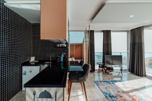 a kitchen with black tiles and a counter top at Fortunella Suites in Finike