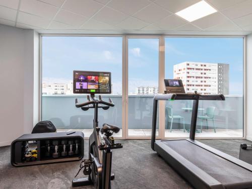 an office with a gym with a treadmill and a tv at ibis Styles Bezons Paris La Défense in Bezons