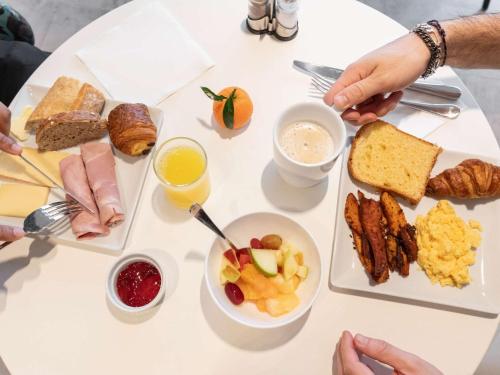 a white table with a lot of breakfast foods at ibis Styles Bezons Paris La Défense in Bezons