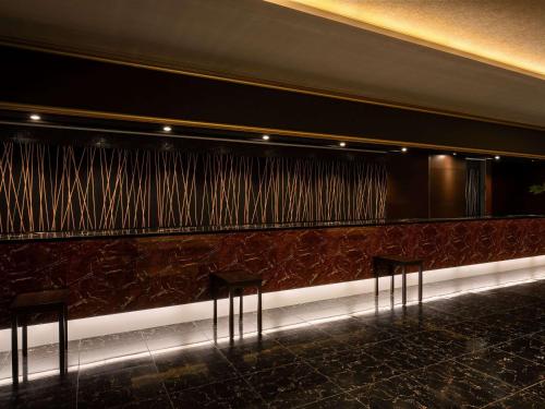 a row of chairs in front of a wall at Grand Mercure Lake Hamana Resort & Spa in Hamamatsu