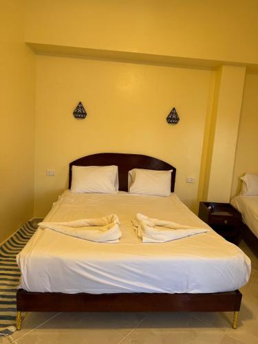 a bedroom with a bed with two towels on it at DoroKa Nubian House in Aswan