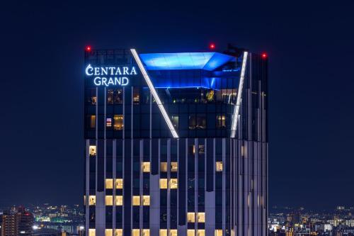 a tall building with a sign on top of it at Centara Grand Hotel Osaka in Osaka