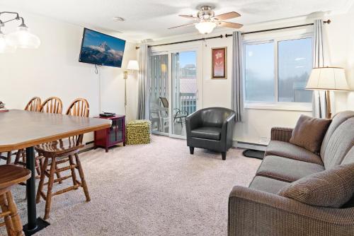 a living room with a couch and a table and chairs at ML231 New Deck Easy Parking WiFi Next To Village in Snowshoe
