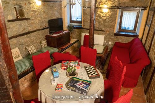 a room with a table and red chairs and a tableablish at Villa Norma in Órma