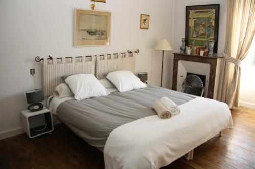 a bedroom with two beds with towels on them at Domaine Labattut in Saint-Astier