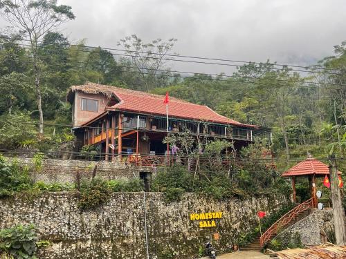 a house on the side of a hill at Pù Luông Sala Homestay in Hương Bá Thước
