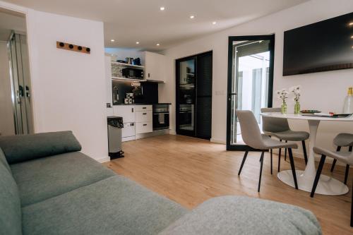 a living room with a couch and a table at Azores Smart Studios in Ponta Delgada