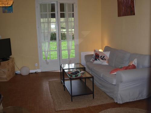 a living room with a couch and a coffee table at Cantebos - Maison avec 3800 m² de jardin in Saint-Laurent-de-Médoc
