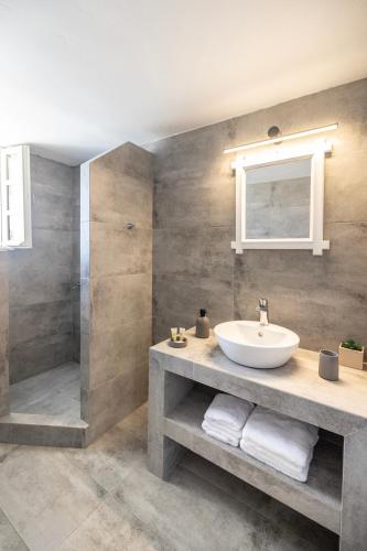 a bathroom with a sink and a shower at Vrachia Studios & Apartments in Oia