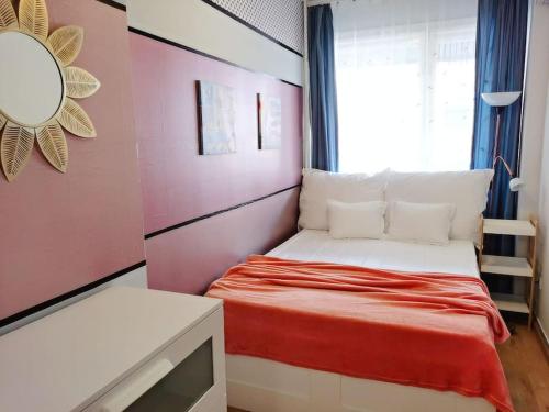 a small bedroom with a bed and a window at Deak Ferenc ter Central Apartment in Budapest