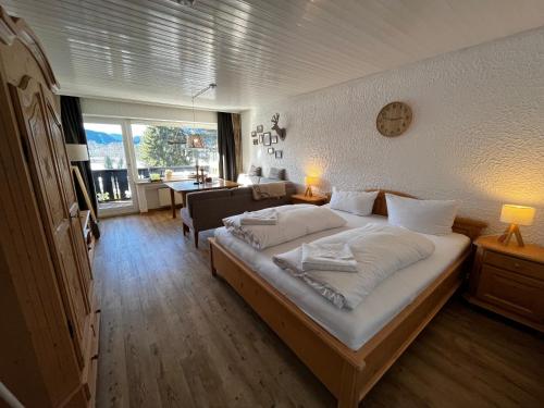 a bedroom with a large bed with white pillows at Appartement An der Ach - 15 in Pfronten