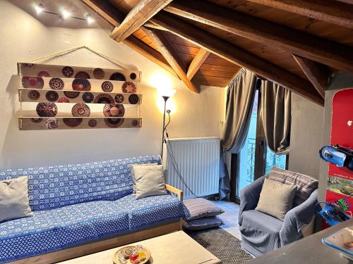a living room with a blue couch and a table at Pandoras House Arachova in Arachova