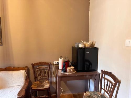 a room with a small table and a black refrigerator at Pandoras House Arachova in Arachova