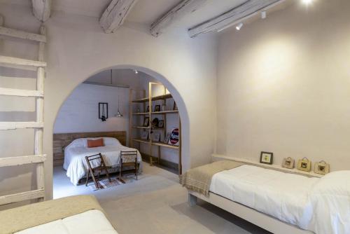 a bedroom with two beds and an archway at Casa Bernardina in Tilcara