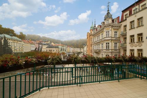 a view of a city with buildings and a fence at EA Hotel Atlantic Palace in Karlovy Vary