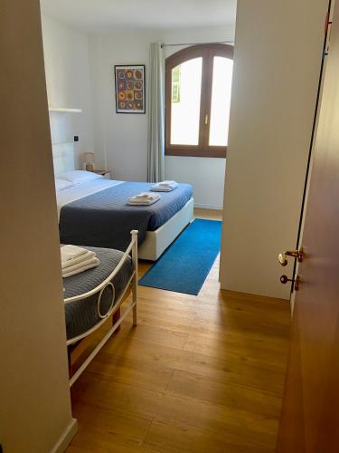a bedroom with a bed and a window and a door at Ada's House in Alghero