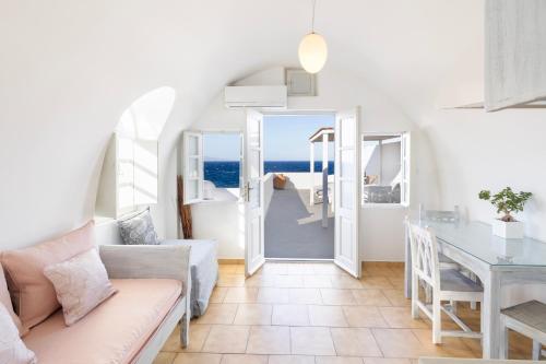 a living room with a couch and a table at Vrachia Studios & Apartments in Oia