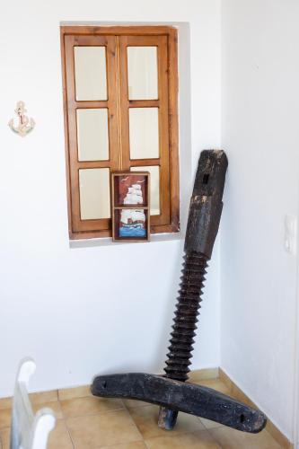 a black broom in the corner of a room at Vrachia Studios & Apartments in Oia