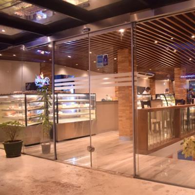 a lobby of a store with glass doors and flowers at Heritage Grand - Badulla in Badulla