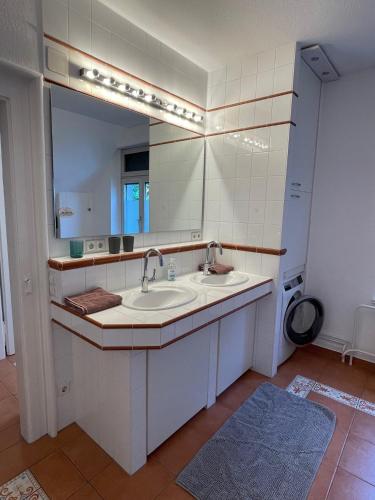 a bathroom with two sinks and a mirror at Zum Hölltor in Überlingen