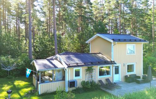 a tiny house with a solar roof on a deck at Gorgeous Home In Fristad With Wifi in Tämta