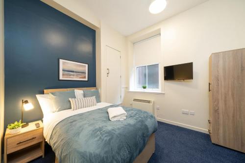 a bedroom with a large bed and a window at Clova at Ben More Apartments in Montrose