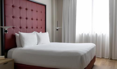 a bedroom with a large bed and a large window at Uma House by Yurbban South Beach in Miami Beach