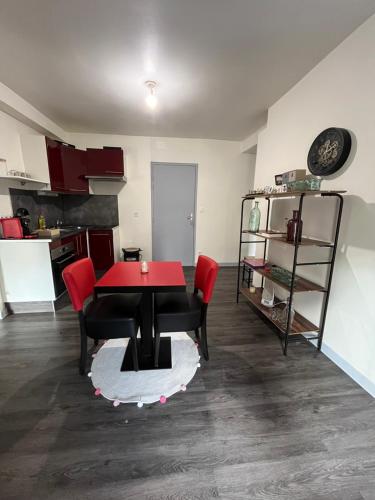 une salle à manger avec une table rouge et des chaises rouges dans l'établissement Style & Confort, à Sainte-Savine