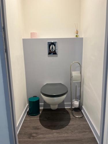 La salle de bains est pourvue de toilettes et d'un siège noir. dans l'établissement Style & Confort, à Sainte-Savine