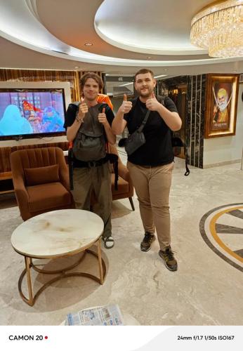 two people standing in a room with their thumbs up at Hotel Glitz - Walk in from New Delhi Railway Station in New Delhi