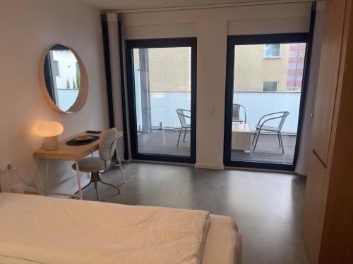 a bedroom with a bed and a table and chairs at Hotel Seeadler in Friedrichshafen