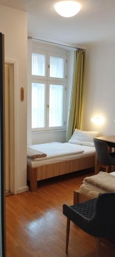 a bedroom with two beds and a window at Ciszterci Szállás Pécs in Pécs