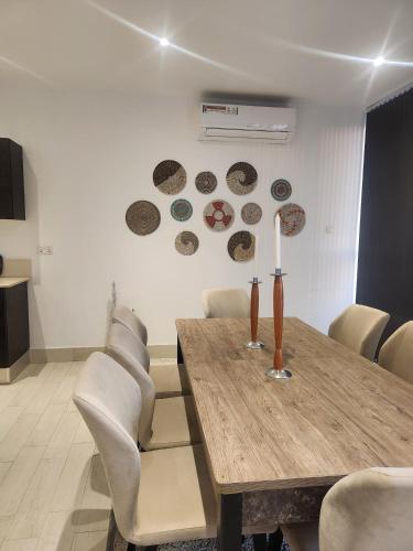 a dining room with a table and some plates on the wall at Stunning 2 Bedroom App at Relax Complex in Bijilo
